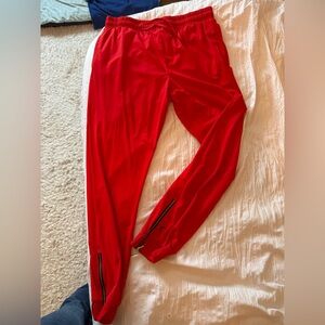 Zyia everywhere joggers in red with gold zipper details